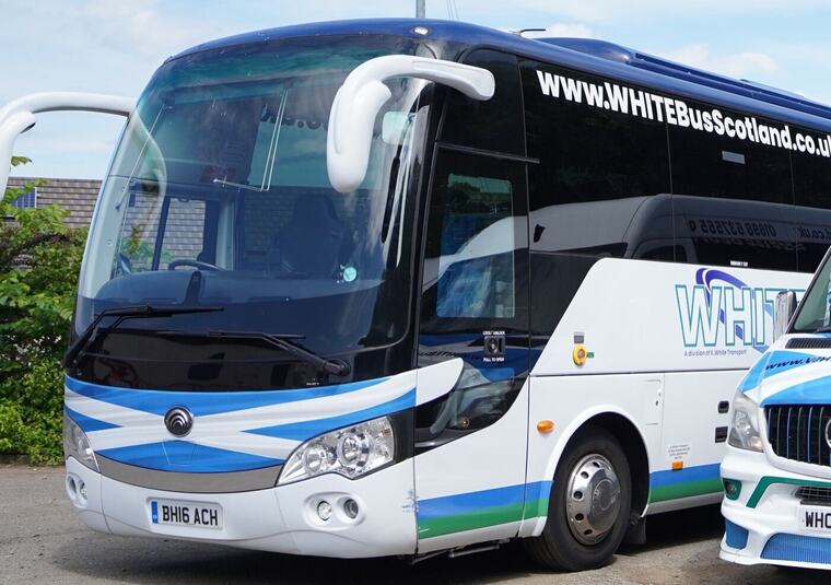A White Bus Scotland coach in blue and white livery